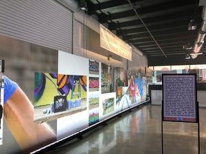 A long wall with a lot of pictures on it .