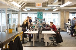 TEAM COLLABORATES WITH COLUMN GRAPHIC IN BACKGROUND