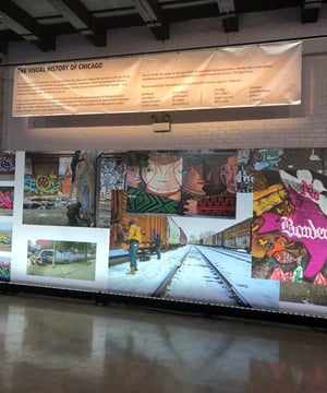 A large wall with a banner that says the visual history of chicago on it .