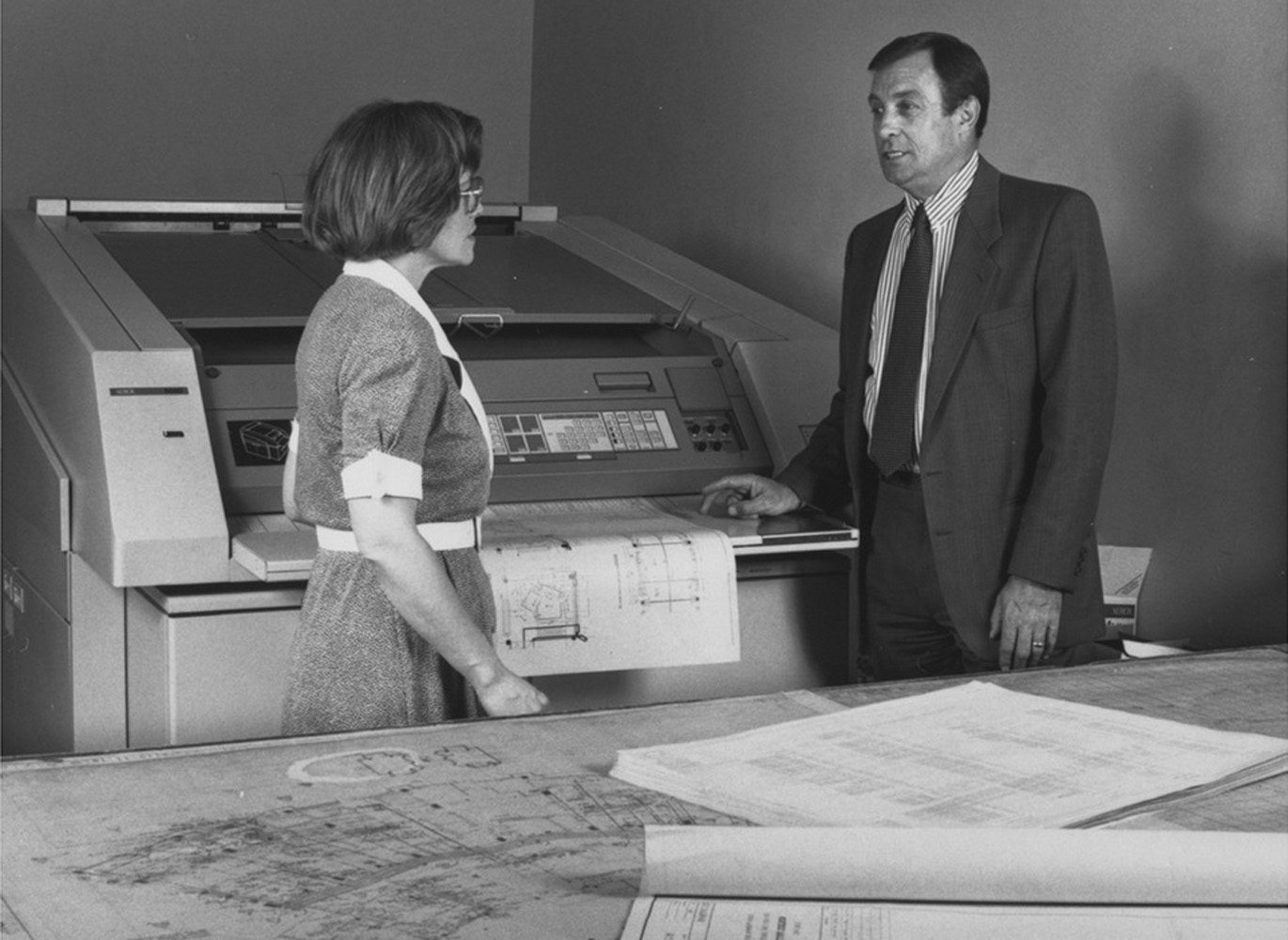 In this image, Mike Duff speaks about new equipment in Cushing print shop.