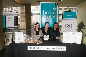 United-States-Artists-Smile-at-Conference-Booth-with-Materials