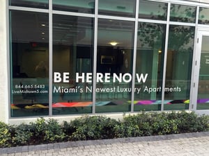 A window with a sign on it that says