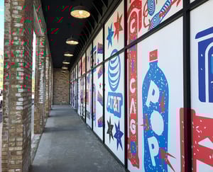 A brick building with a row of windows that say at & t and pop