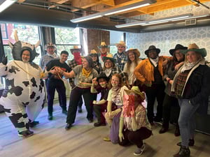 Cushing employees gather in the office wearing costumes reminiscent of western films.