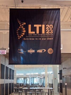 Hanging banner for Reyes' LTI 2023 Long-Term Initiative Program, featuring bold branding and clear event messaging