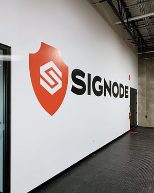 Signode's logo sized and positioned as a photo backdrop on the second level of the warehouse. 