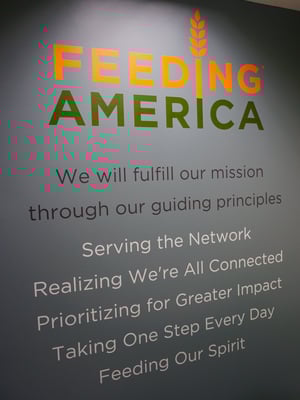 Vinyl wall graphic at Feeding America's office that states their mission statement.