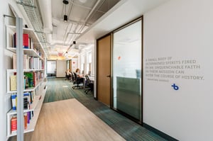 Vinyl wall graphic shows quote in an office setting.