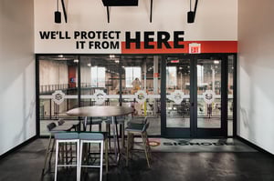 “We’ll protect it from here” welcomes visitors with confidence and clarity at Signode's warehouse threshold.