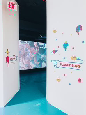 A wall at the SlooMoo institute uses vinyl decals to direct visitors to the next station.