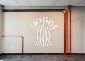 Wall graphic featuring a bundle of wheat at Zekelman Industries' office