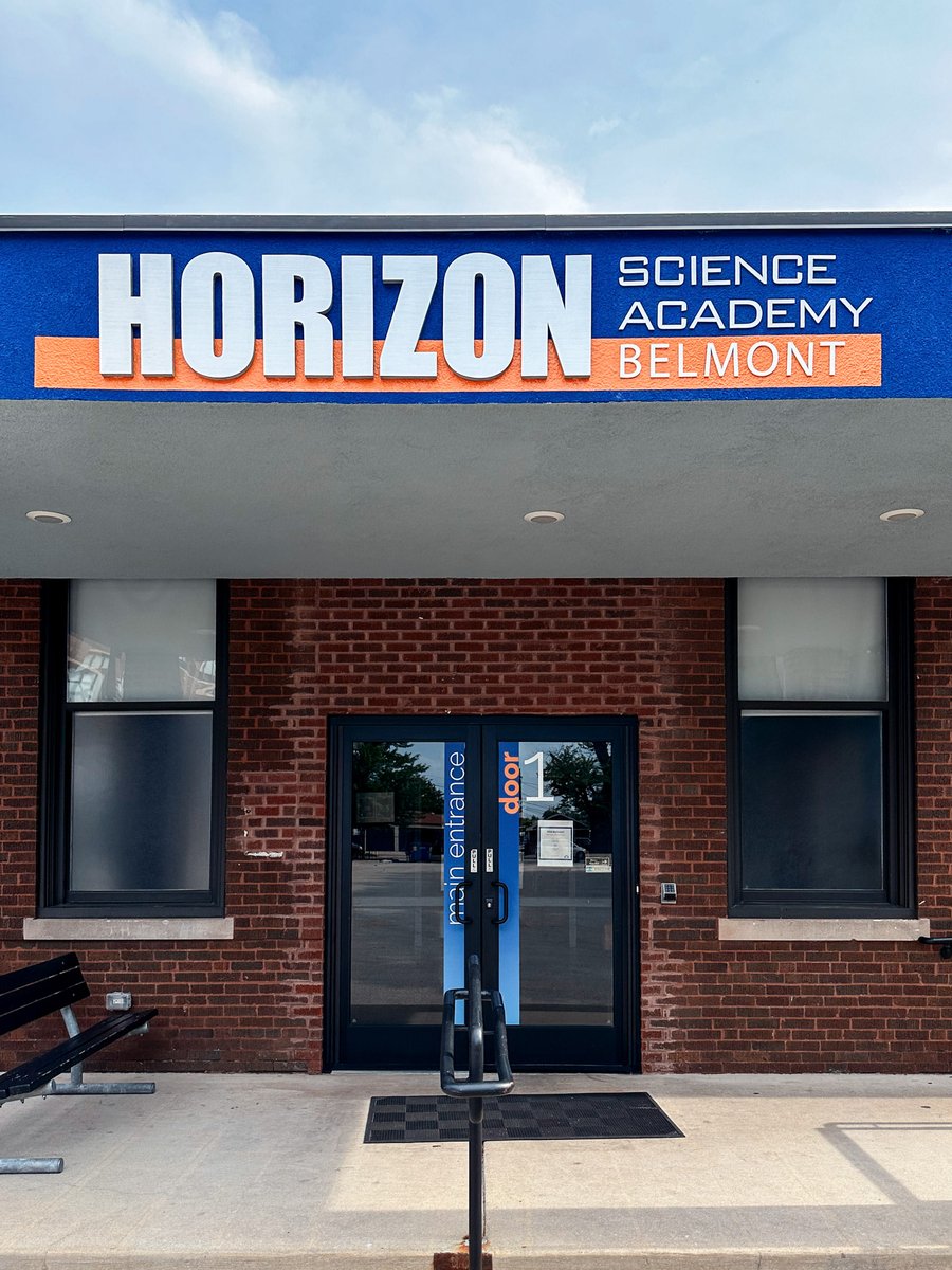 Front door of horizon science academy labeled "main entrance" in school colors