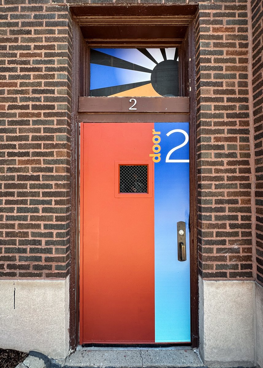 School door labeled "Door 2" with school's colors.
