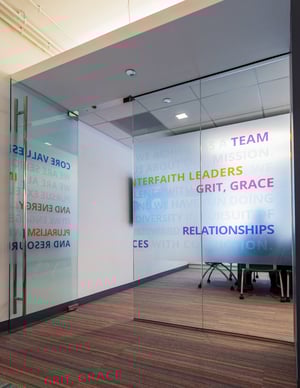 Decorative privacy film surrounds a conference room with descriptive words.