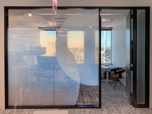 Conference room window wall covered with circular frosted privacy glass.